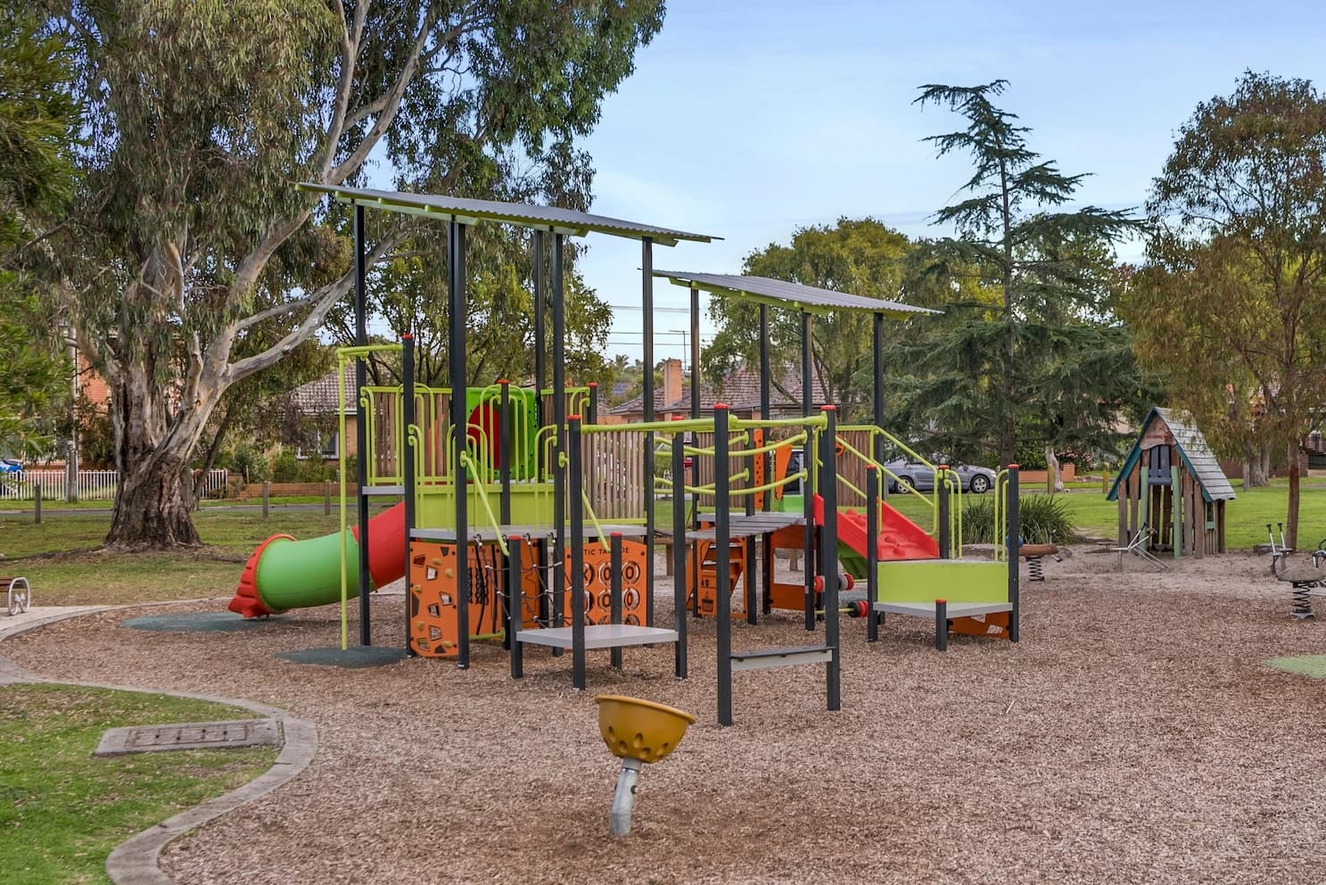 Playground equipment with climbing panels, slides and loose-fill surfacing